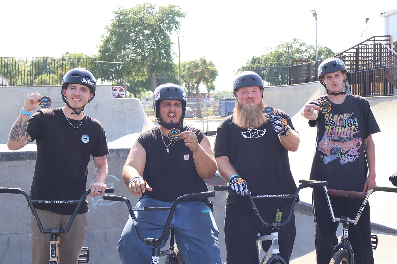 4 bikers at a skatepark