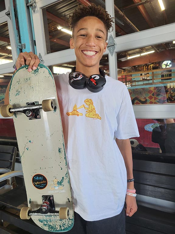 Skater at Tampa Skatepark of tampa smiling while holding skateboard