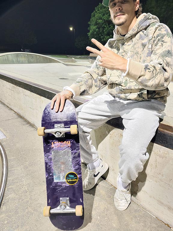 Skater making peace sign while looking into camera